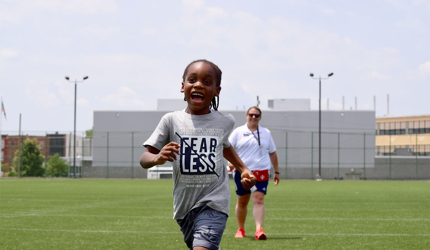 Young boy running on ball field
