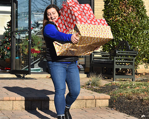 Volunteer carrying Christmas gifts