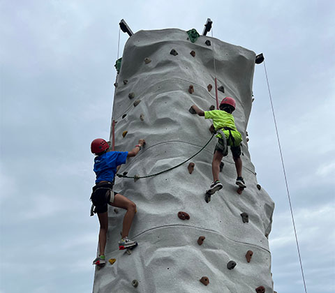 Campers climbing a rock wall