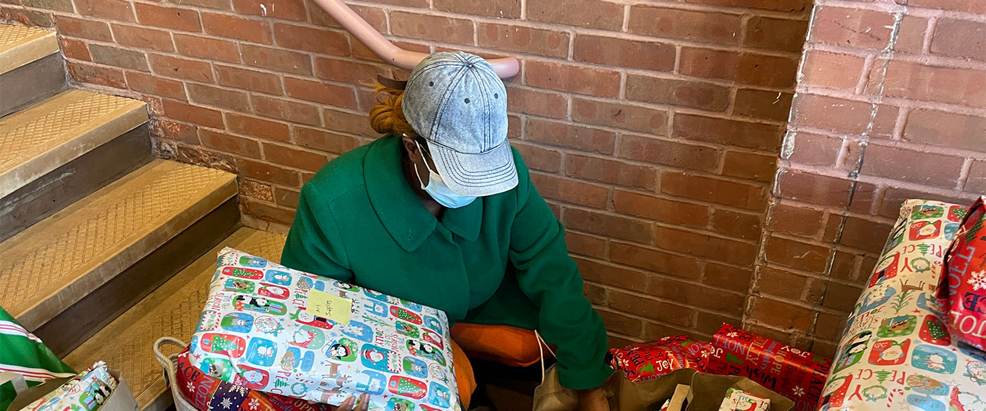 Volunteer organizing Christmas gifts